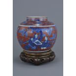 A Chinese 18/19th century underglaze blue and copper red jar decorated with figures in a garden scen