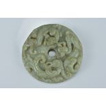 A large Chinese celadon jade jadeite bi disc carved with two dragons and one phoenix. 7Cm diameter
