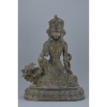 A Chinese 18th century Chinese bronze Guanyin seated on a mythical beast with traces of gold gilding