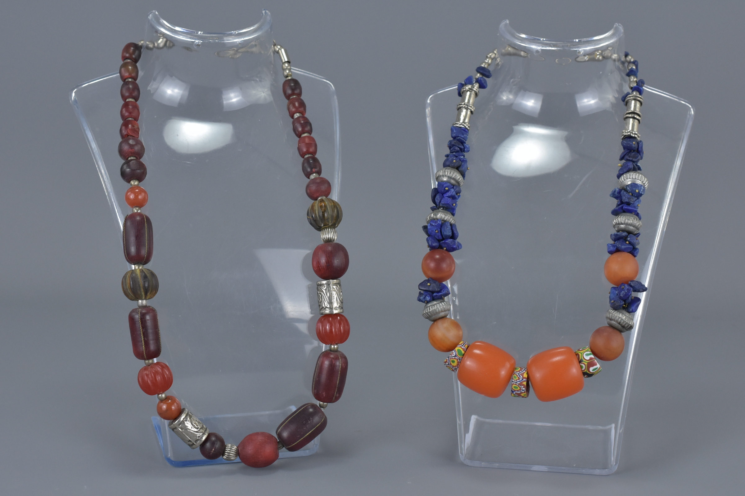 Two Ethnic Necklaces with wooden, resin, white metal and stone beads