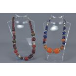 Two Ethnic Necklaces with wooden, resin, white metal and stone beads