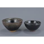 A Chinese oil spot pottery tea bowl together with one other. 13Cm and 10cm diameters. (2)