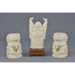 A pair of carved ivory Chinese dogs of foo with Ch