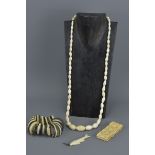 Four items of Ivory and Bone Jewellery including Bead Necklace, Two Bracelets and a Fish Shaped Pend