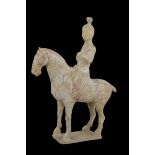 A Chinese Tang dynasty pottery horse and female rider valued by Bluett & Sons in 1958