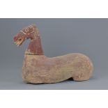 A Chinese Han dynasty pottery seated horse