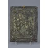 A bronze metal plaque depicting King Arthur
