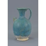 A Persian turquoise glazed pottery ewer