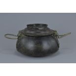 A Chinese Han dynasty bronze cooking pot