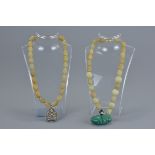 Two jade beaded necklaces with pendants