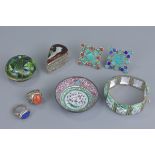 A group of seven white metal and enamel items