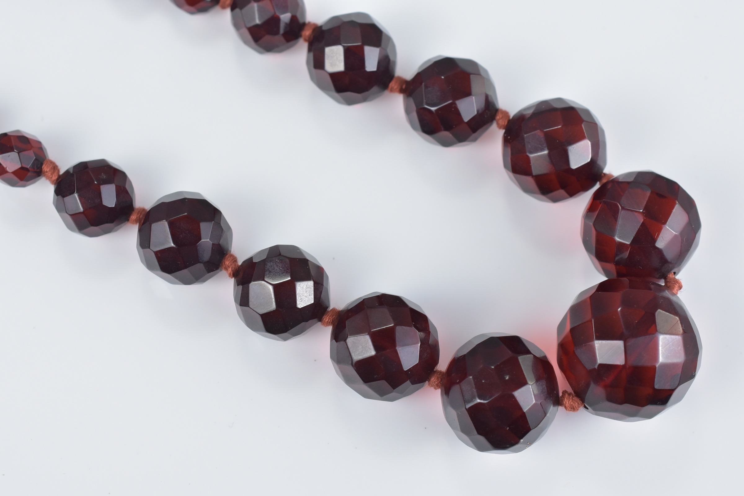 String of Seventy Three Faux Cherry Amber Faceted beads - Image 3 of 3