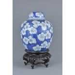 A large Chinese blue and white porcelain ginger jar on stand