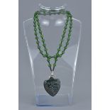 A jade bead necklace with hard stone pendant