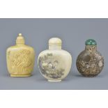 Three Chinese 19th century Snuff Bottles including a Fossilized Stone example and Two Ivory Examples
