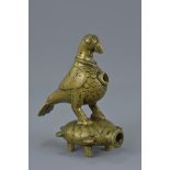 A Middle Eastern bronze fitting in the form of a bird and turtle on for legs. 11cm tall