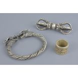 A white metal dragon bangle together with rotating ring and vajra. Bangle approx. 7.5 cm. Vajra. 9.5