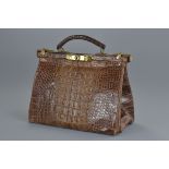 A vintage crocodile leather women's handbag with bronze fittings. No key unable to open. 26cm length