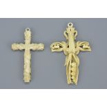 Two 19th century Ivory Crosses, one carved with Lily of the Valley, 9cms high and the other with ent