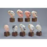 Nine early 20th century Chinese Painted Pottery Heads of Theatrical Men on wooden stands, average 5c