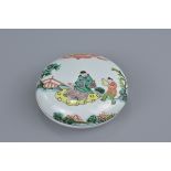 A Chinese 19th century famille verte porcelain box and cover decorated with figures. 8.5cm diameter