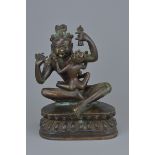 A 19th century Tibetan Bronze seated figure of Mahasiddha Ghantapa holding a bell and vajra with sep