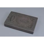 A heavy Chinese 'Duan' Stone Ink Stone / block with small well with carved dragon and floral pattern