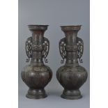 Pair of Large Japanese Bronze Vases, each with Twin Handles held by Mythical Creatures, Meiji Period