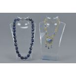 A large lapis lazuli beaded necklace together with one white metal and lapis stone necklace (2)