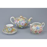 Chinese Three Piece Tea Service comprising Teapot, Milk Jug and Cup & Saucer with Million Flower Des