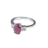 A white gold ring with central faceted cabochon ruby ring