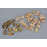 Approx. 28 natural unpolished amber stone pieces. (28)