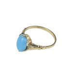 A 9ct gold ring with light blue cabochon.