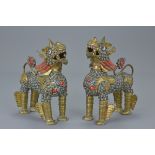 Pair of Cambodian Metal Lions inset with Coloured Stones, 14cms high (2)