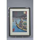 A Japanese framed woodblock print of two Geisha on a boat. Signed. Frame 31.5cm x 42cm