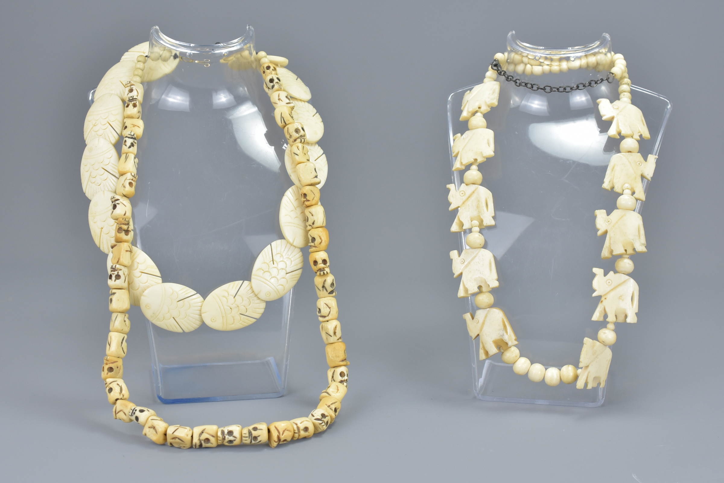 Three carved bone necklaces. (3)