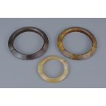 Three Chinese Agate Bangles / Rings, largest 9.5cms diameter (3)
