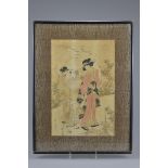 A framed and glazed 19th century Japanese woodblock print by Kikukawa Eizan (1787-1867) of two Geish