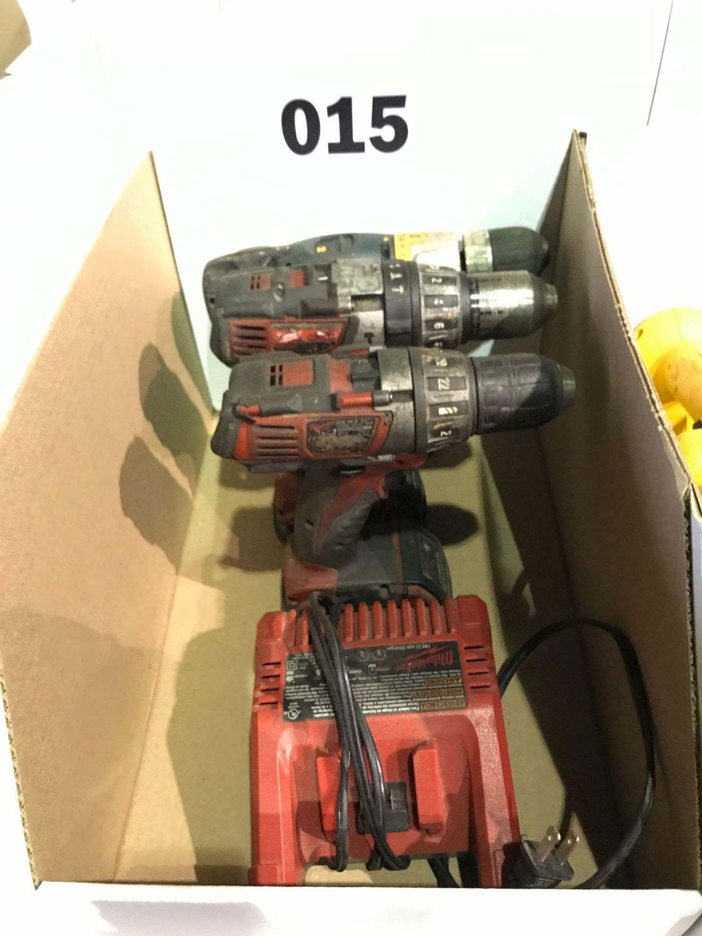 (2) Milwaukee Cordless Drills, (1) Dewalt Cordless Drill, (1) Charger