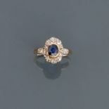 Bague deux ors, 750 MM, centrée d'une pierre bleue entourée de diamants taille [...]