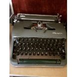 A green Olympia typewriter, in working order.