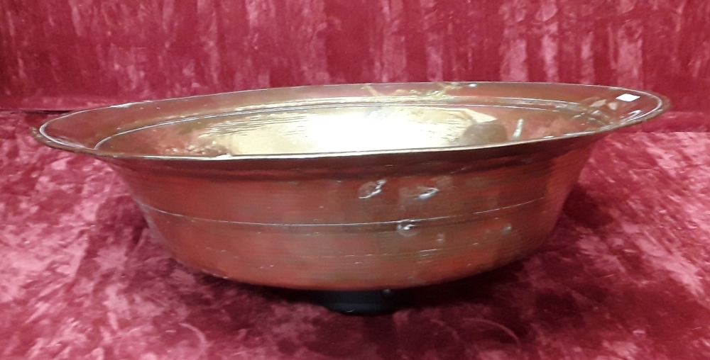 A large heavy hammered brass bowl.