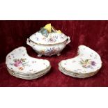 Six crescent shaped dishes and a lidded tureen.