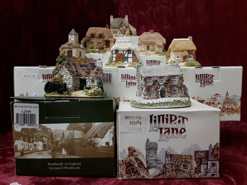 A collection of eight boxed Lilliput Lane cottages.