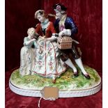 A German porcelain figure group depicting a couple seated with a child.