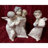 A pair of Lladro figurines in the form of cherubs.