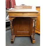 An late Victorian oak davenport desk with rising lid