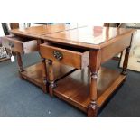Two matching mahogany side tables each with a small drawer and shelf.