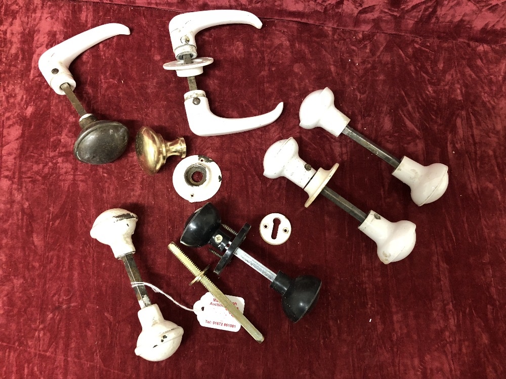 A collection of vintage bakelite and metal door handles.