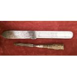 A WW1 US Army aluminium handled mess knife together with a WW1 trench art nail file.